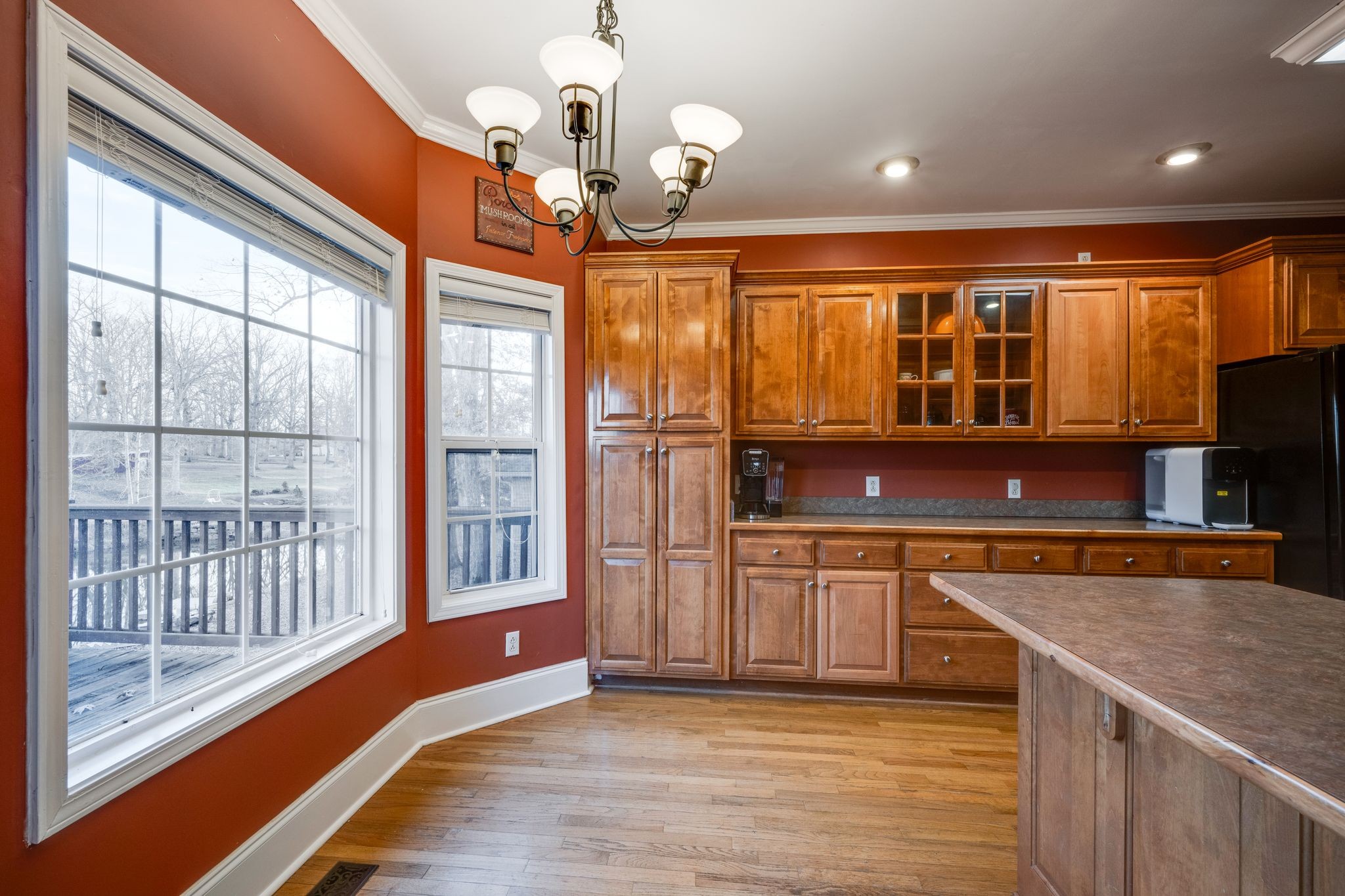 754 Hafner Road Charlotte, TN 37036 - Photo 18 of 54 a kitchen with stainless steel appliances granite countertop a stove top oven a sink dishwasher a dining table and chairs with wooden floor