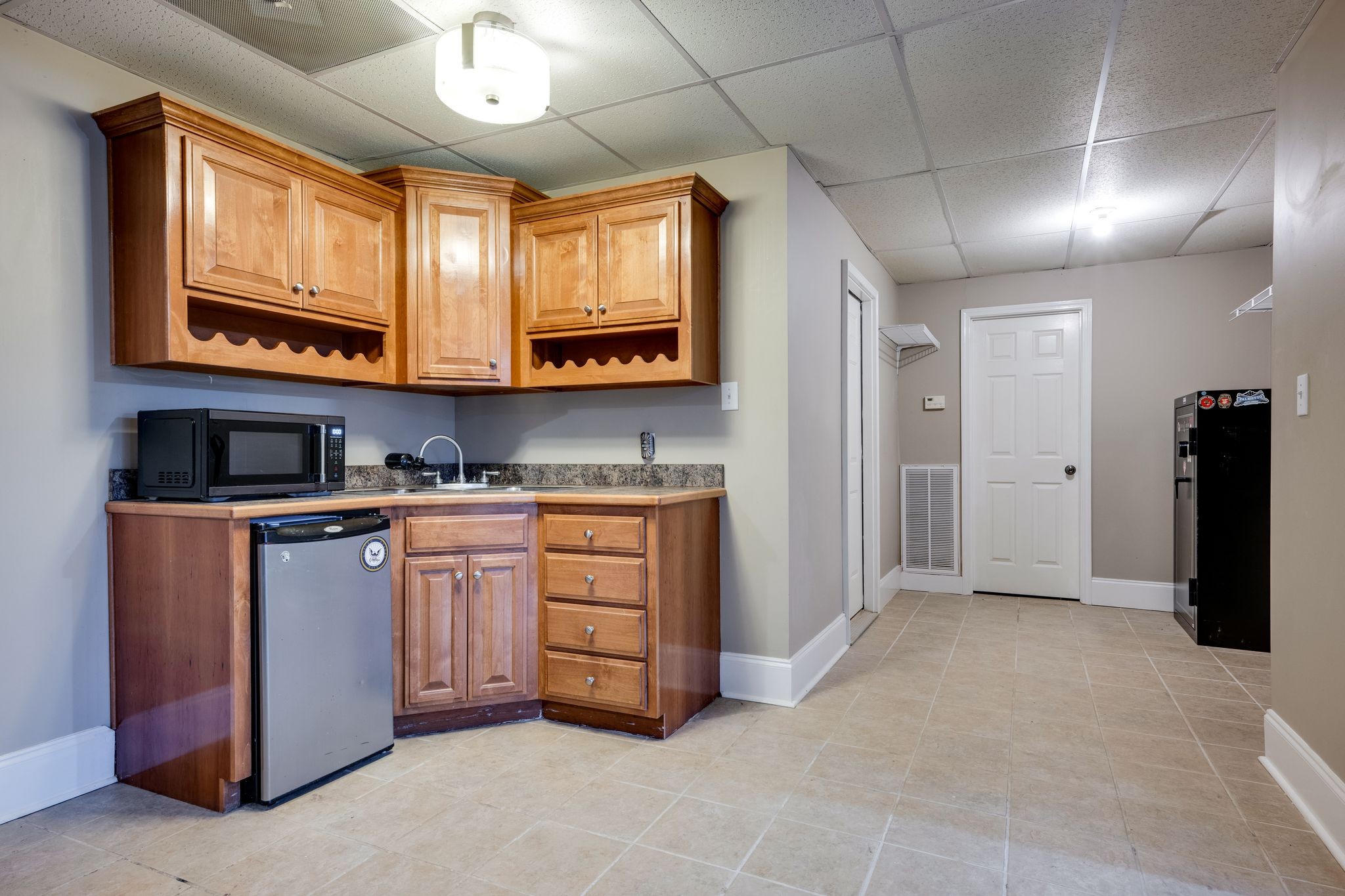 754 Hafner Road Charlotte, TN 37036 - Photo 32 of 54 a kitchen with stainless steel appliances granite countertop a stove a sink and a refrigerator