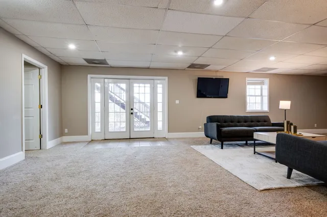 a living room with furniture and a walk in closet