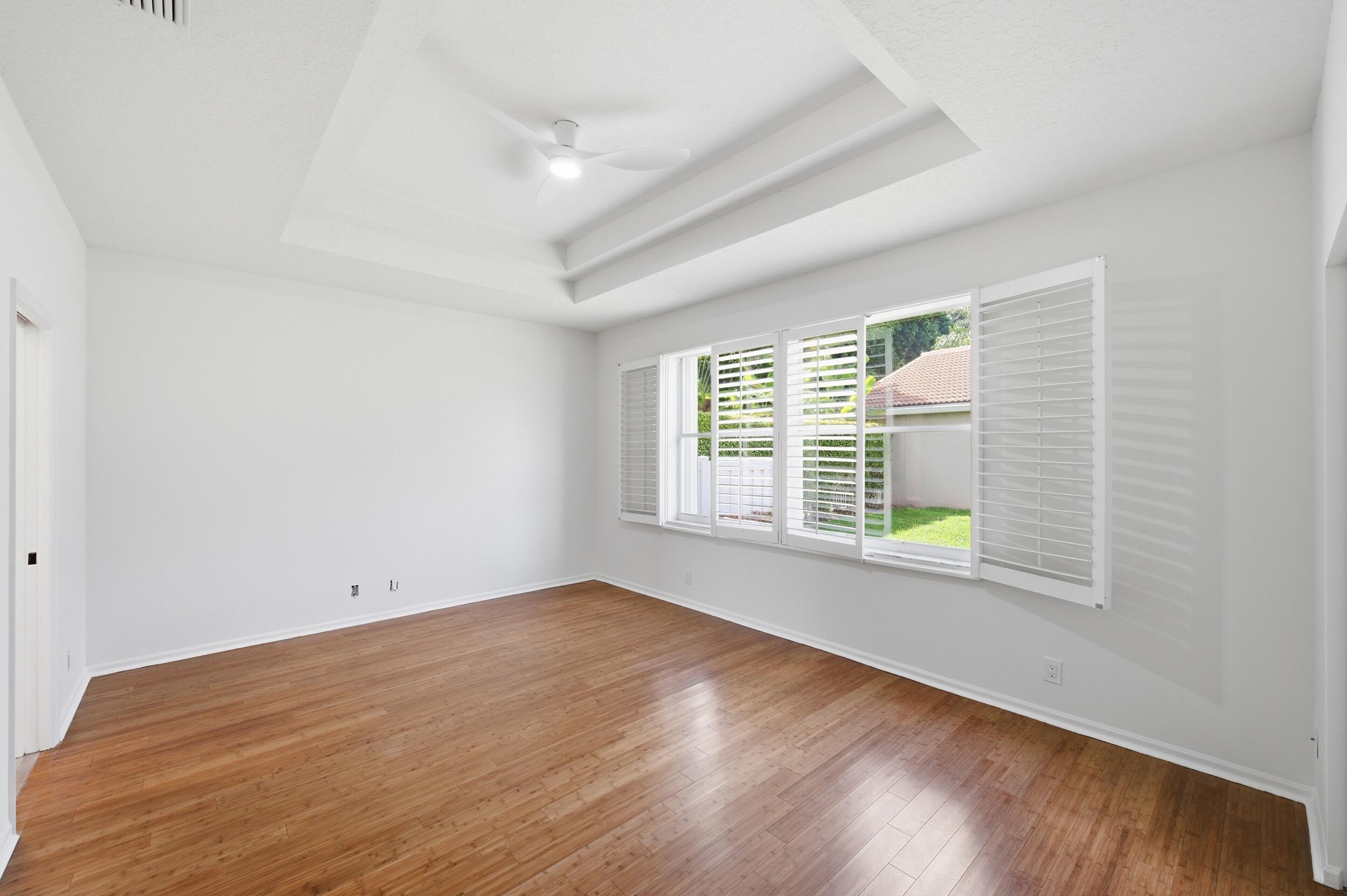8534 Vía D Oro Boca Raton, FL 33433 - Photo 23 of 34 an empty room with wooden floor and windows