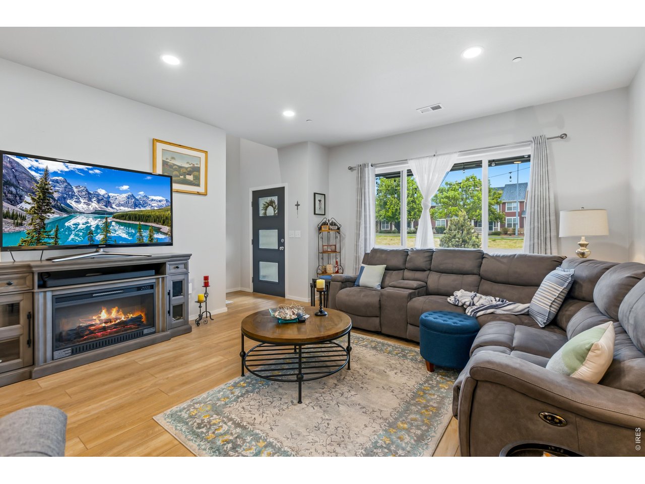 6609 4th St Road, Unit 4 Greeley, CO 80634 - Photo 7 of 41 a living room with furniture a flat screen tv and a fireplace