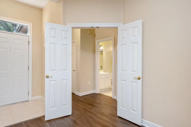 an empty room with wooden floor & door