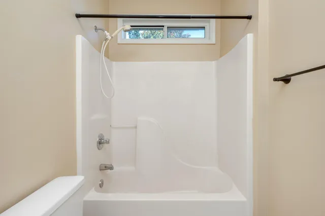 a bathroom with a bathtub and a shower