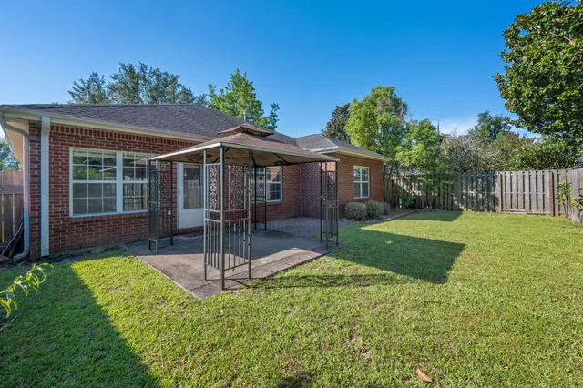 a view of a house with a yard and a garden