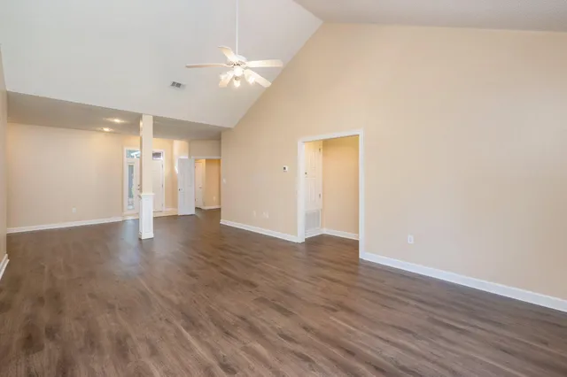 a view of an empty room with wooden floor