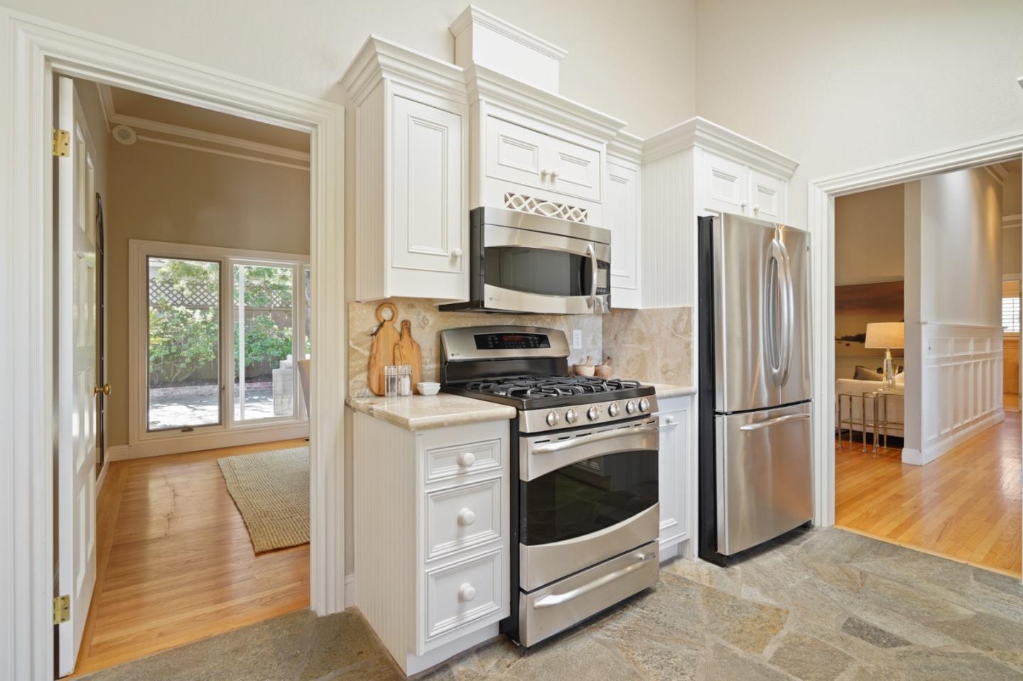 251 Gramercy Drive San Mateo, CA 94402 - Photo 13 of 40 a kitchen with a stove a refrigerator and a stove top oven