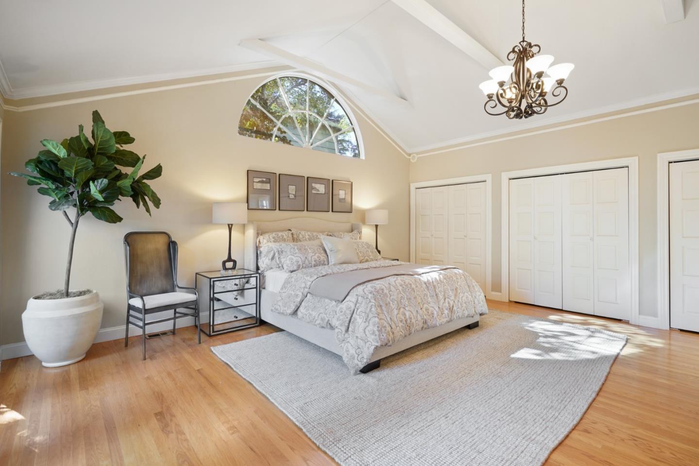 251 Gramercy Drive San Mateo, CA 94402 - Photo 30 of 40 a bedroom with a bed and a chandelier