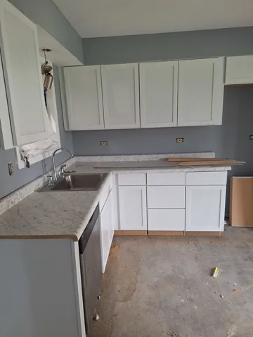 a kitchen with a sink and cabinets