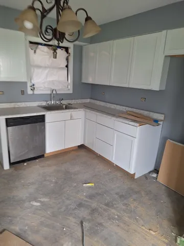a kitchen with stainless steel appliances granite countertop a sink and cabinets