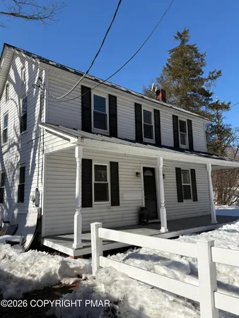 a view of a house with wooden fence