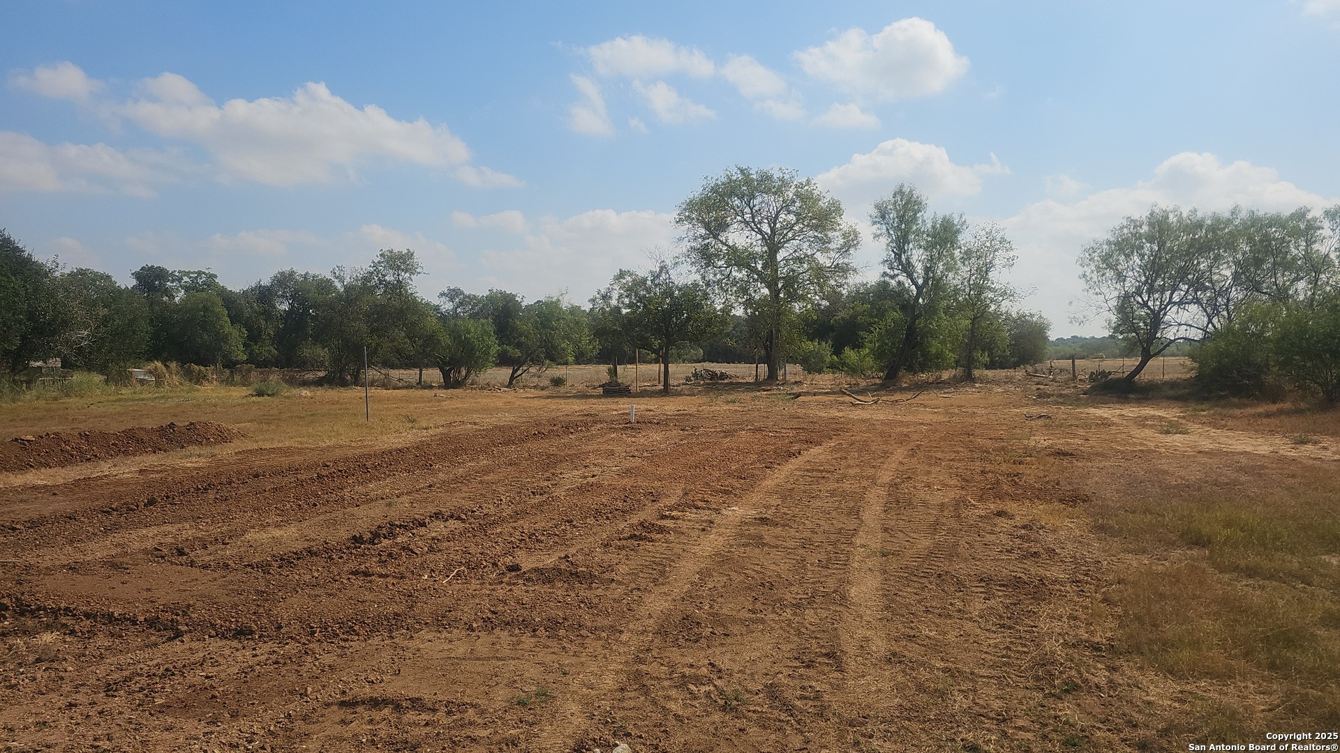 18000 Wisdom Road Lytle, TX 78052 - Photo 3 of 6 a view of dirt field with large trees