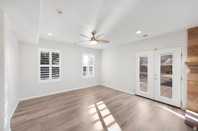 1440 West 100 South Virgin, UT 84779 - Photo 18 of 45 Spacious room featuring wood-finish flooring, two windows with plantation shutters, recessed lighting, and a ceiling fan