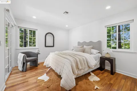 a bedroom with a bed and a large window