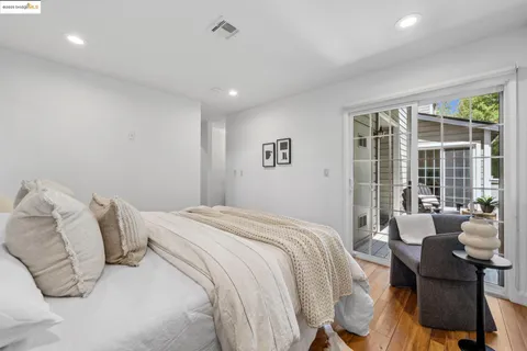 a bedroom with a bed and glass window