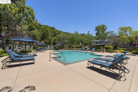 a view of swimming pool with chairs