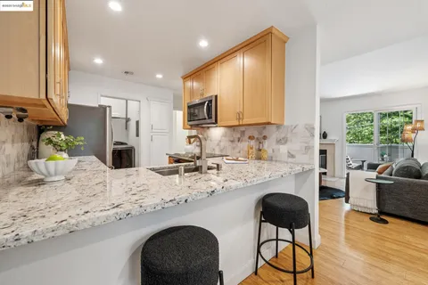 a kitchen with granite countertop sink cabinets and living room
