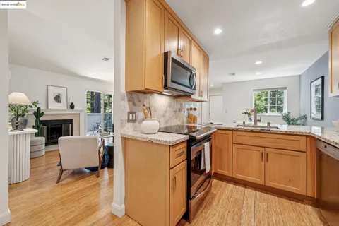 a kitchen with cabinets and wooden floor