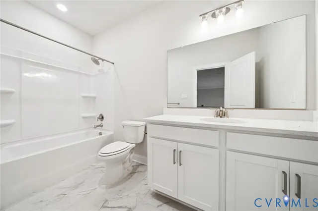 a bathroom with a double vanity sink toilet mirror and bathtub