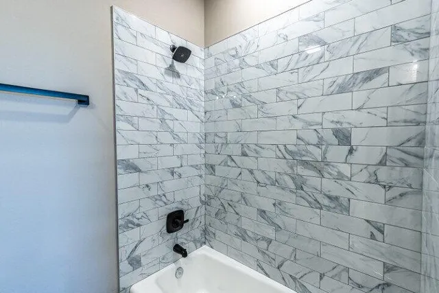 a bathroom with a bathtub and shower