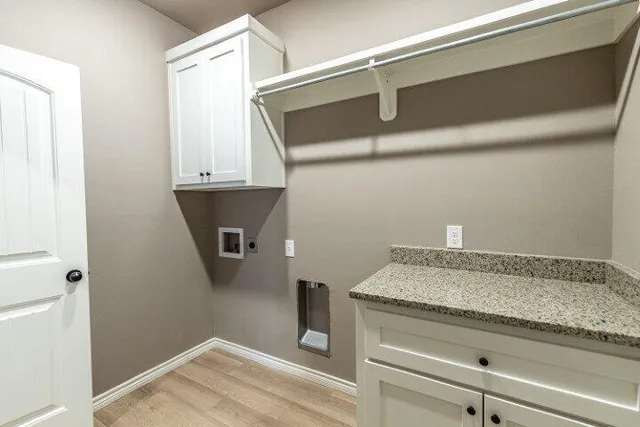 a bathroom with a granite countertop sink and white cabinets