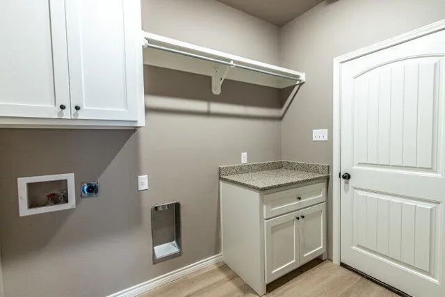a kitchen with white cabinets and a stove