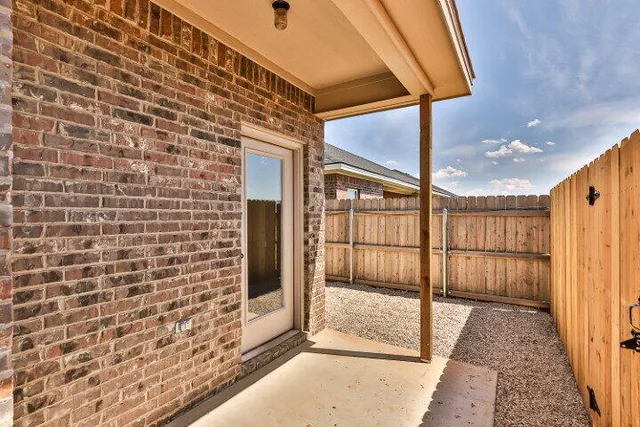 a view of a brick wall with a large window