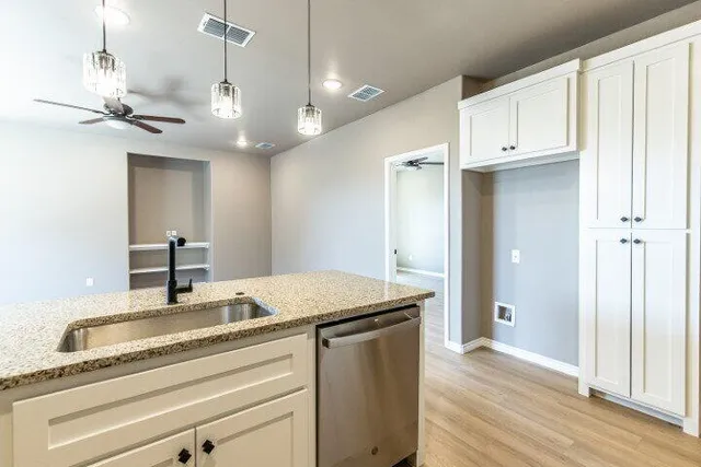 a view of a kitchen from a hallway