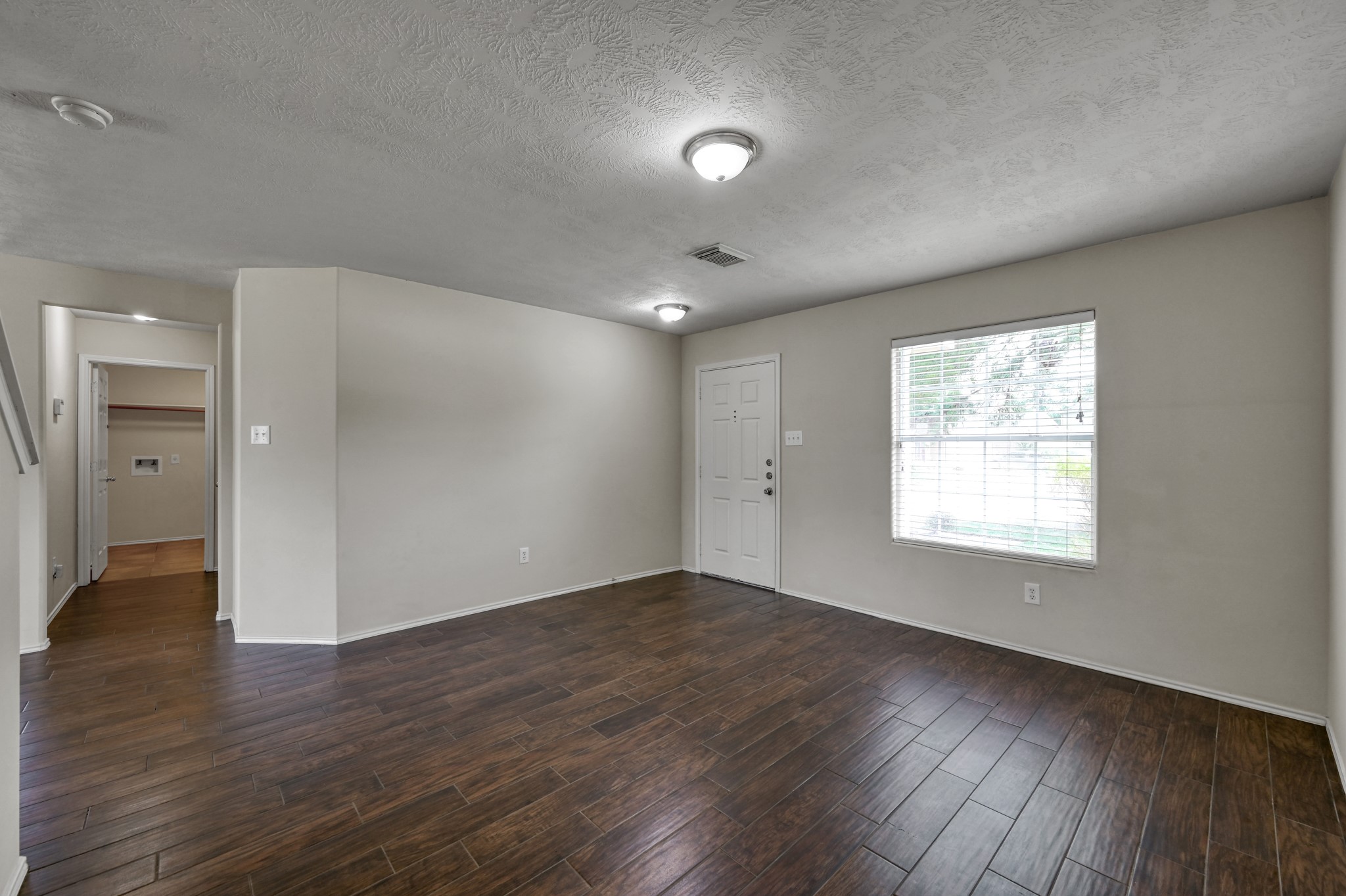 23919 Kingbriar Drive Spring, TX 77373 - Photo 7 of 33 The open-concept layout provides a seamless view from the dining area to the front entry, enhancing the home's spacious feel.