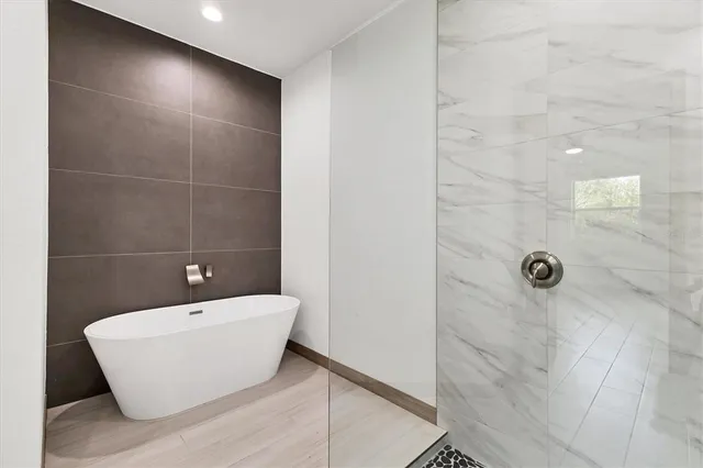 a bathroom with a bathtub and shower