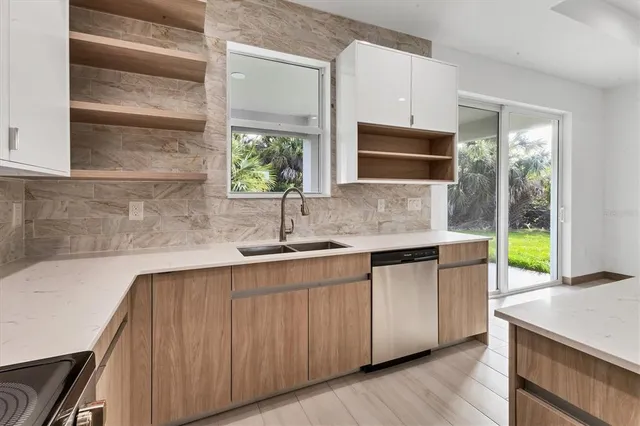 a kitchen with stainless steel appliances a sink stove and cabinets