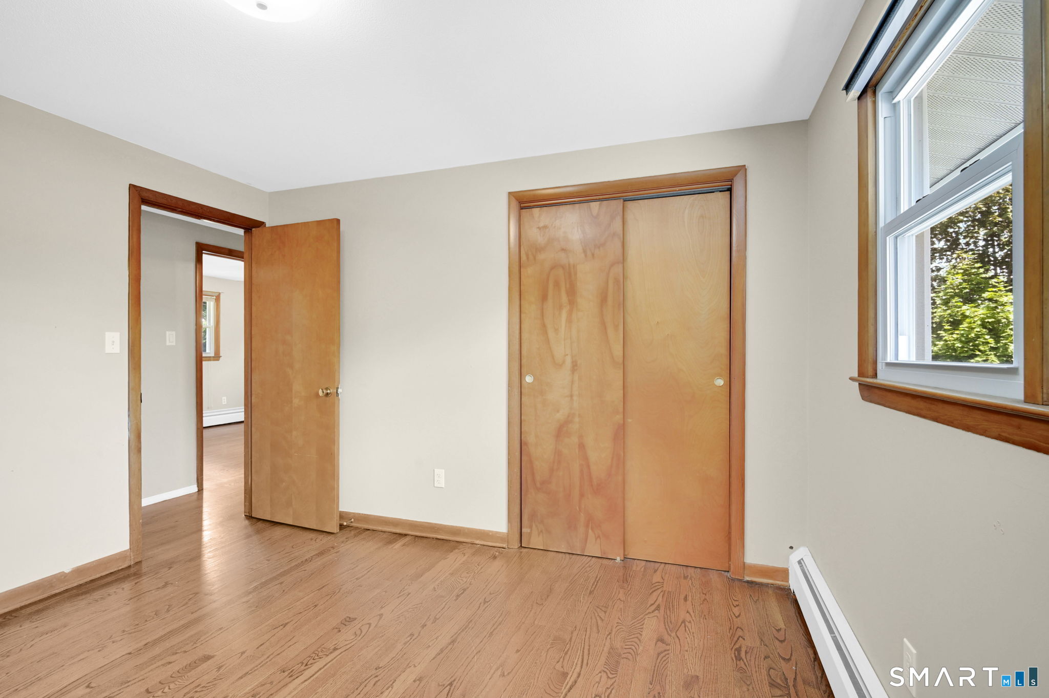 7 Rogers Drive Meriden, CT 06450 - Photo 25 of 40 a view of an empty room with wooden floor and a window