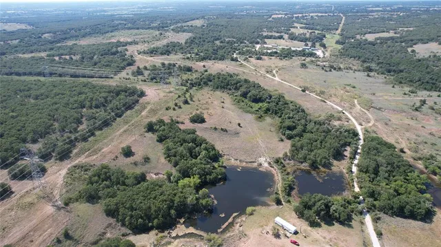 an aerial view of mountain with yard