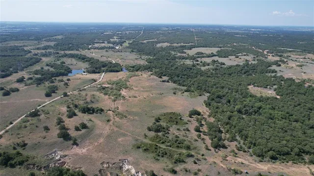 an aerial view of house with yard