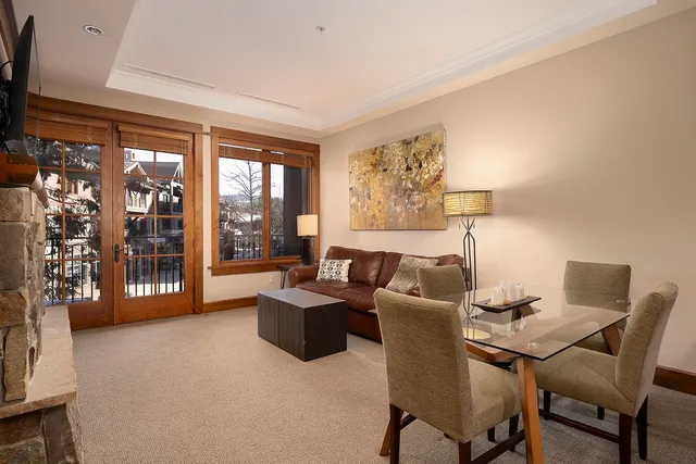 a living room with furniture and a floor to ceiling window