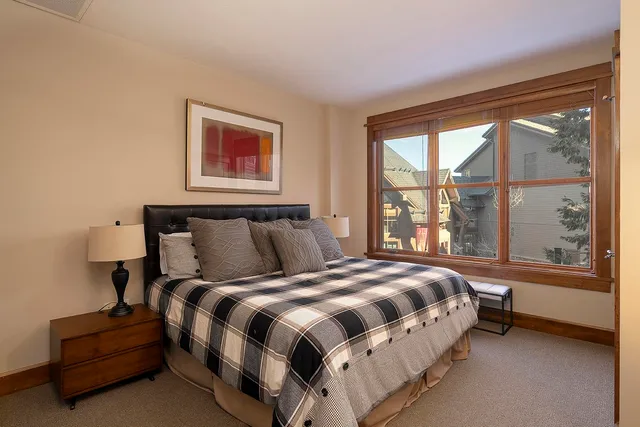 a bed sitting in a bedroom next to a window