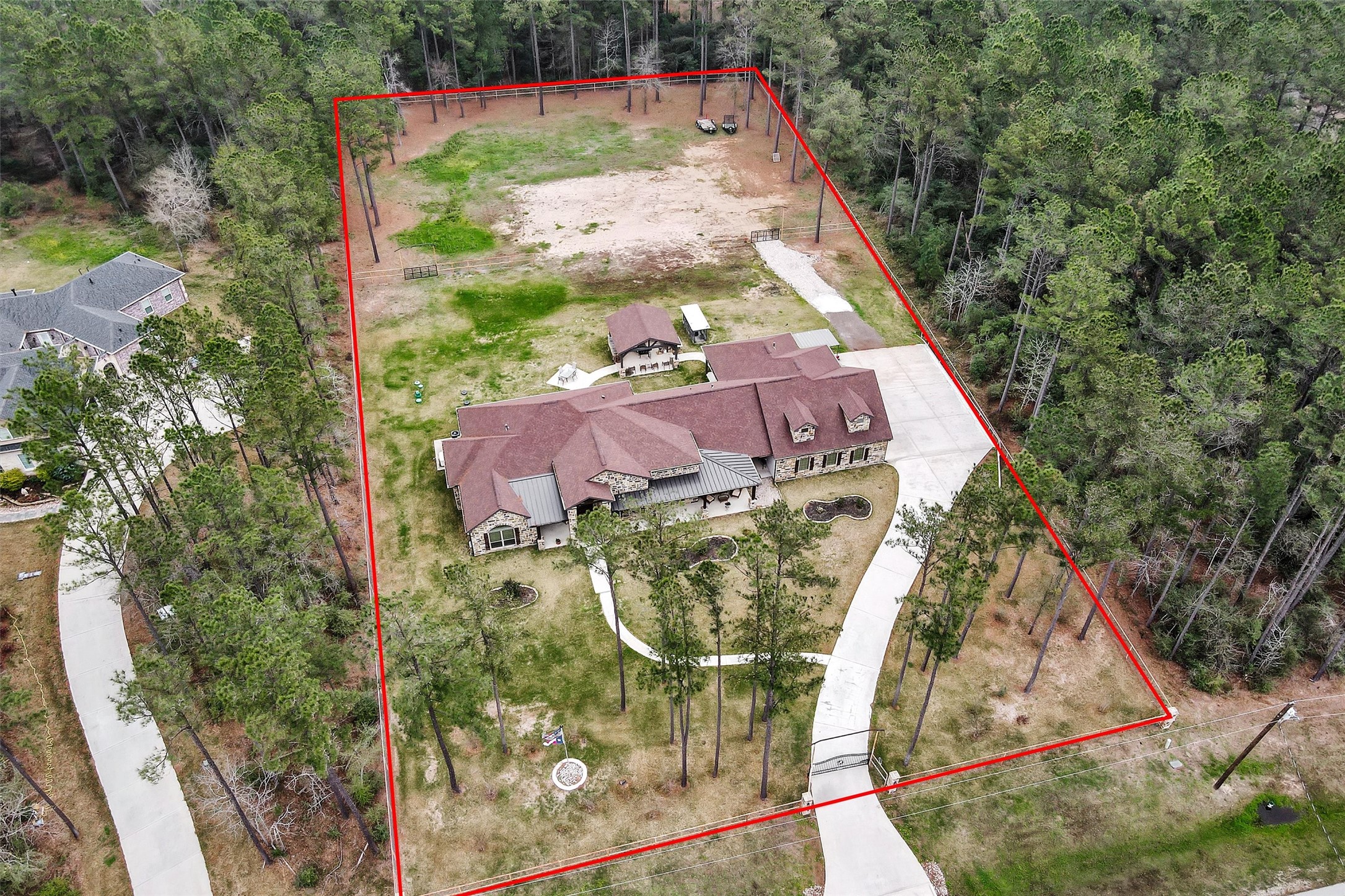 264 Grey Feather Road Huntsville, TX 77340 - Photo 31 of 31 Aerial drone view showing the full acreage estate, home, and outdoor amenities.