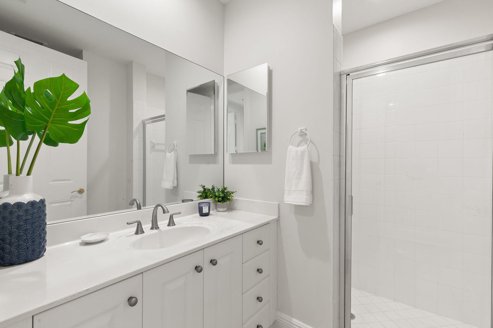9213 Museo Circle, Unit 103 Naples, FL 34114 - Photo 22 of 47 a bathroom with a double vanity sink and a mirror
