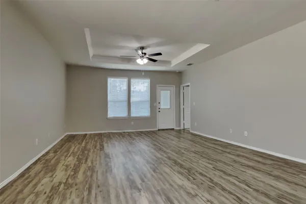 wooden floor in an empty room with a window