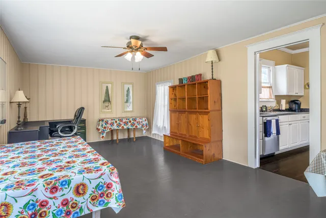 a bedroom with a bed a table and a chandelier