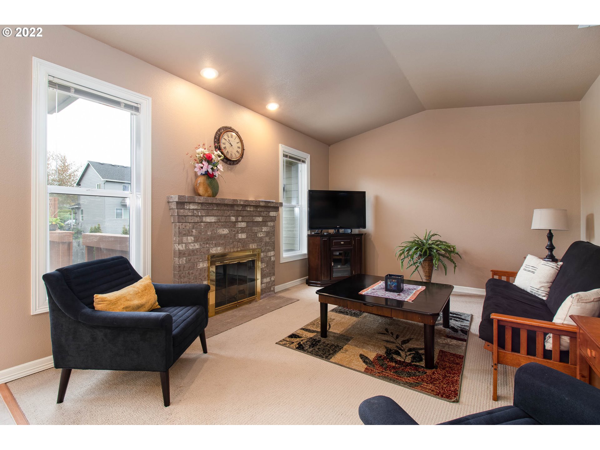 2131 Southeast 12th Avenue Camas, WA 98607 - Photo 14 of 32 a living room with furniture a rug and a fireplace