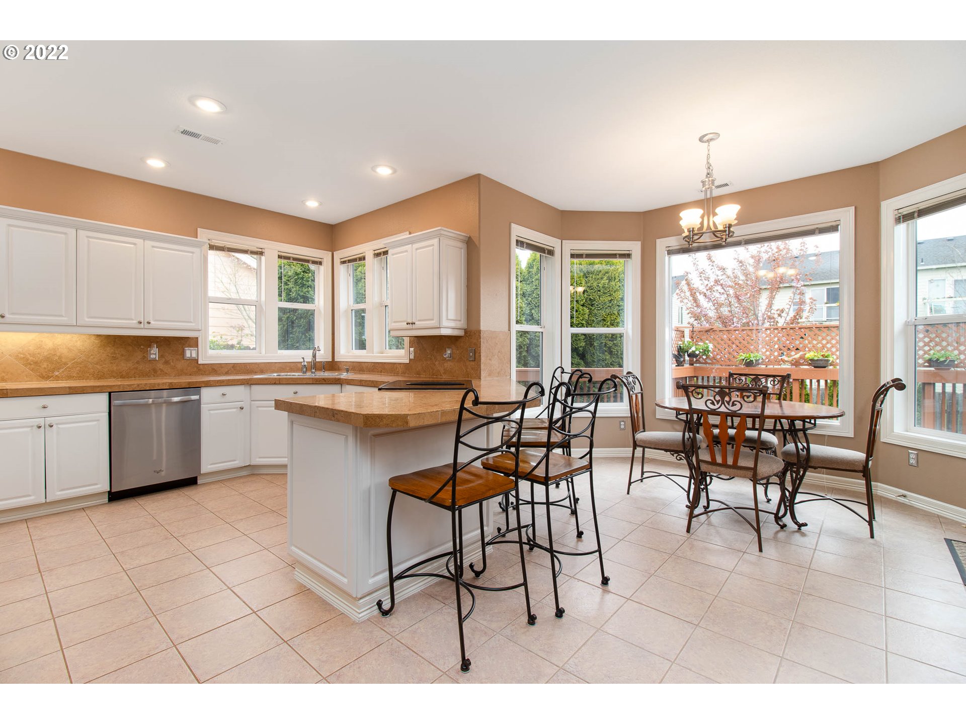 2131 Southeast 12th Avenue Camas, WA 98607 - Photo 10 of 32 a kitchen with stainless steel appliances kitchen island granite countertop a stove a sink a dining table and chairs with wooden floor