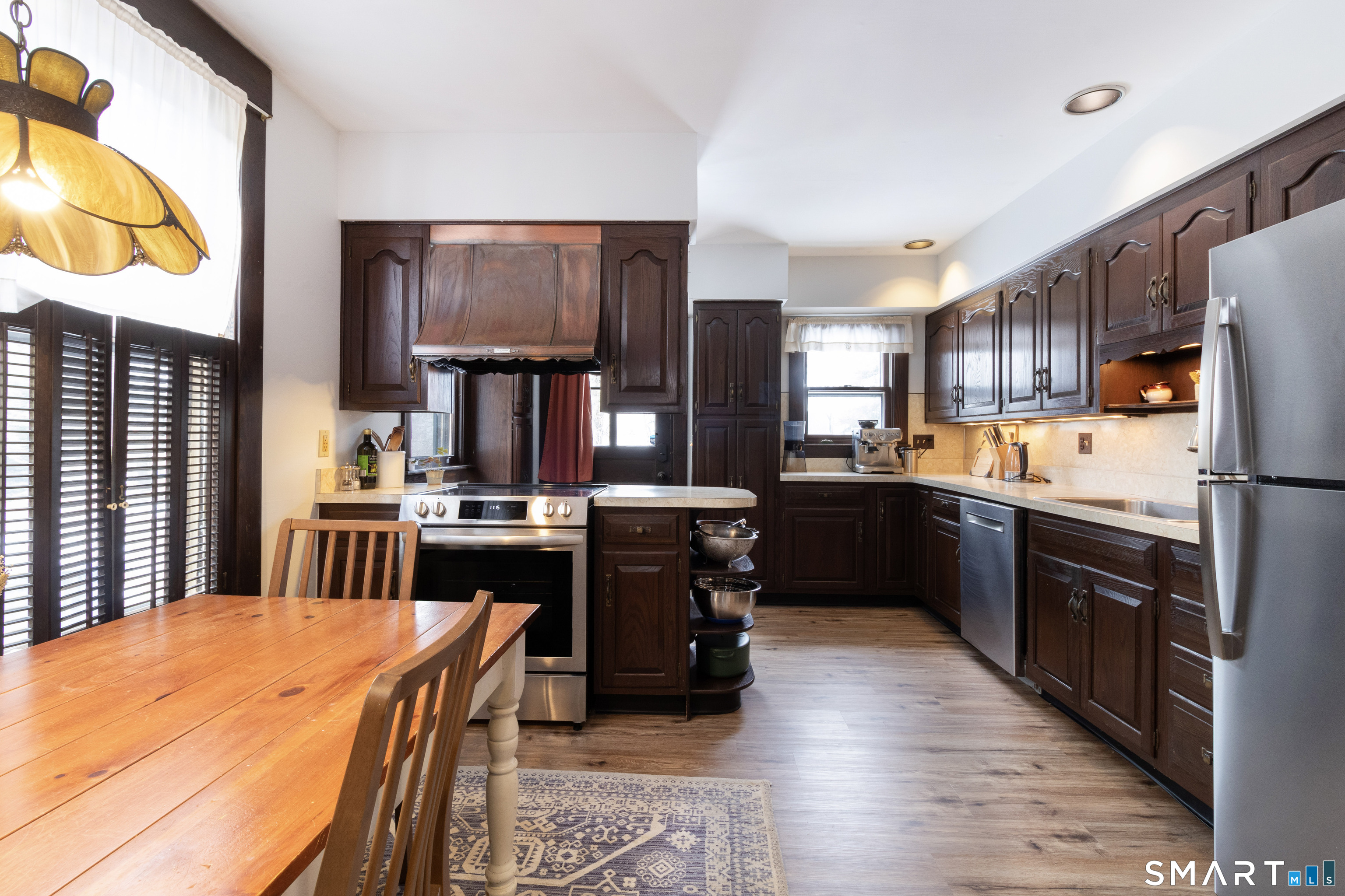319 South Main Street Wallingford, CT 06492 - Photo 17 of 37 a kitchen with stainless steel appliances granite countertop a refrigerator a stove top oven a sink dishwasher and wooden cabinets