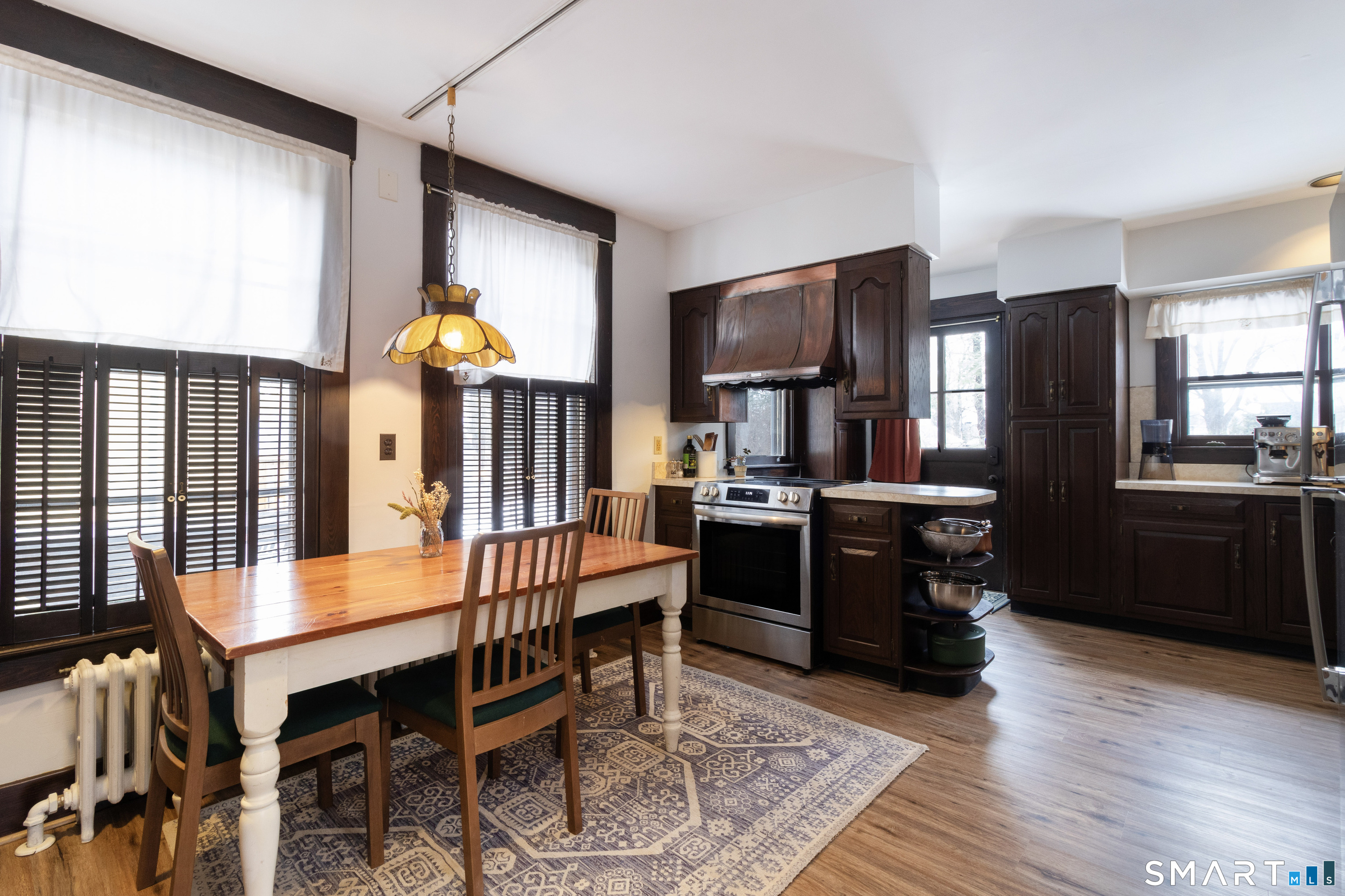 319 South Main Street Wallingford, CT 06492 - Photo 19 of 37 a kitchen with stainless steel appliances kitchen island granite countertop a refrigerator a stove a sink dishwasher and a dining table with wooden floor