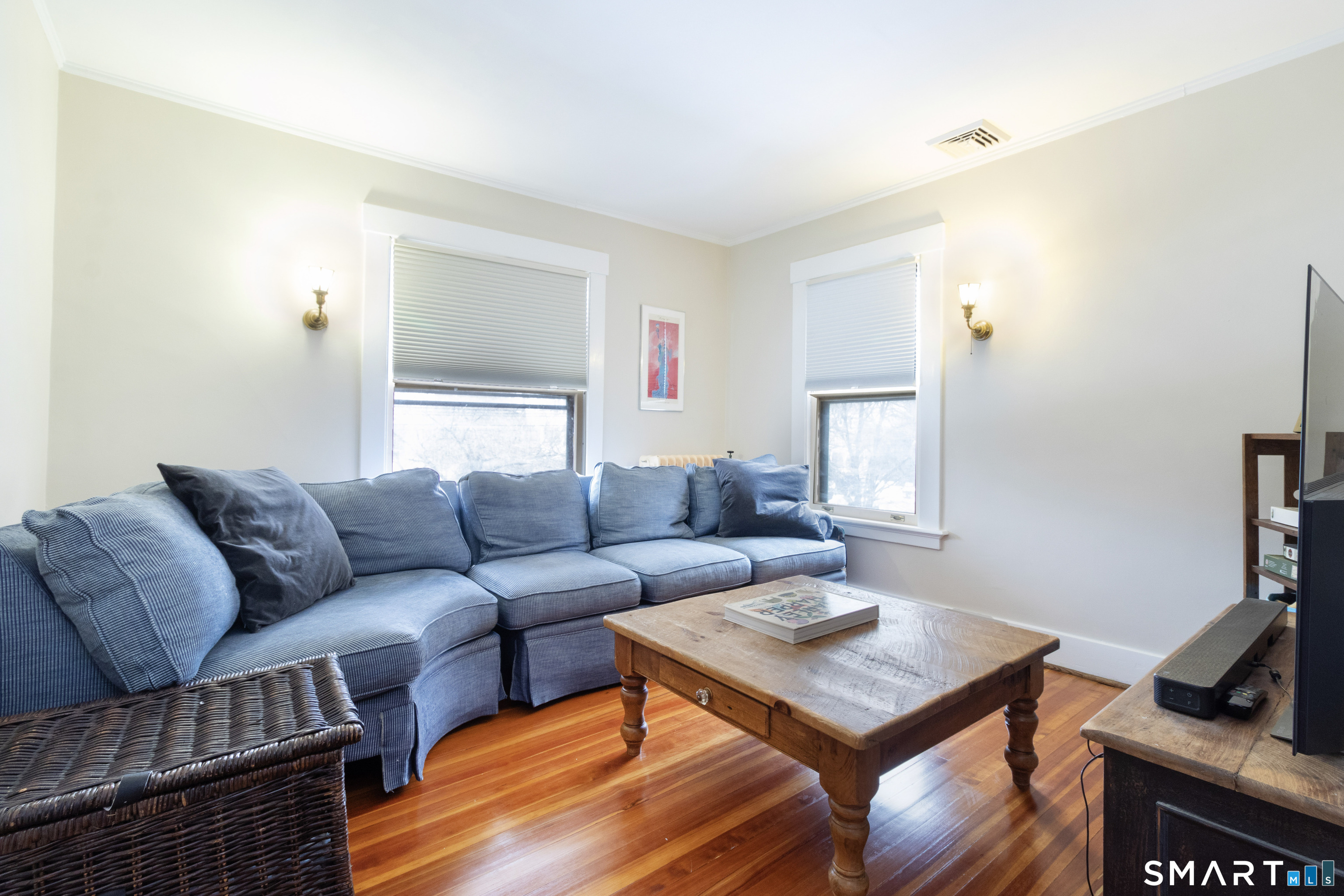 319 South Main Street Wallingford, CT 06492 - Photo 26 of 37 a living room with furniture a flat screen tv and a window
