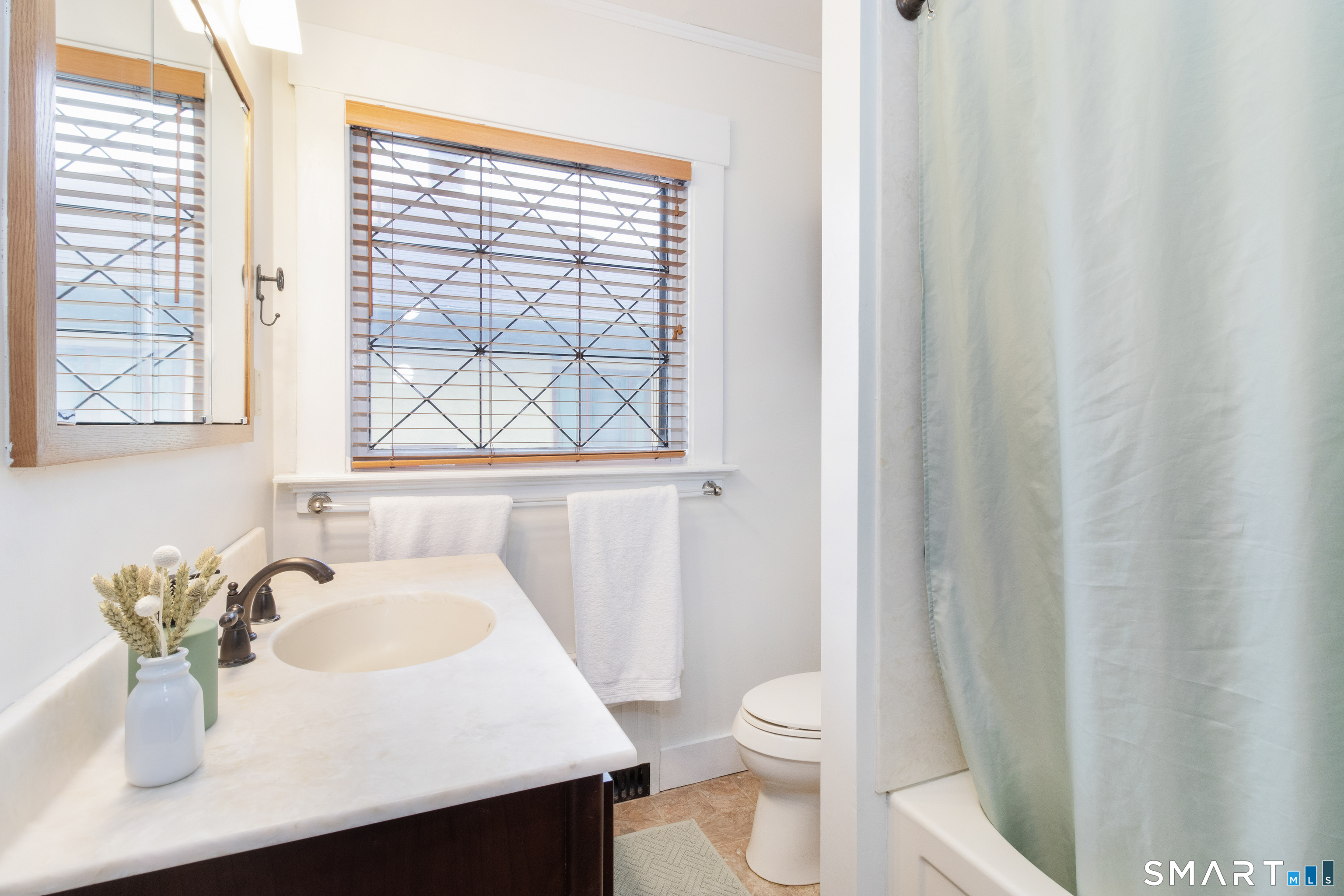 319 South Main Street Wallingford, CT 06492 - Photo 27 of 37 a bathroom with a sink toilet and window