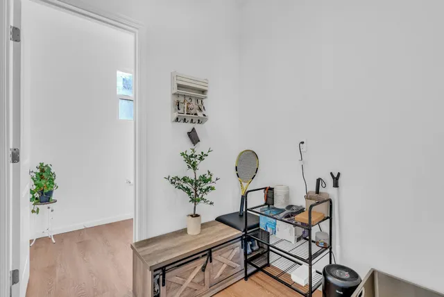 a view of a workspace room with furniture and wooden floor