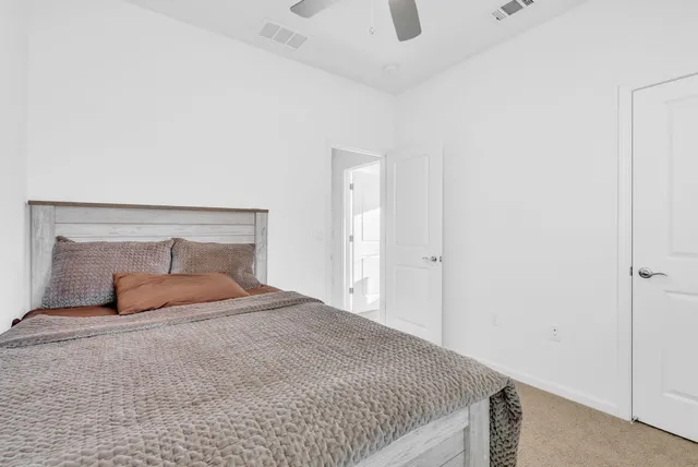 a bedroom with a bed and a night stand