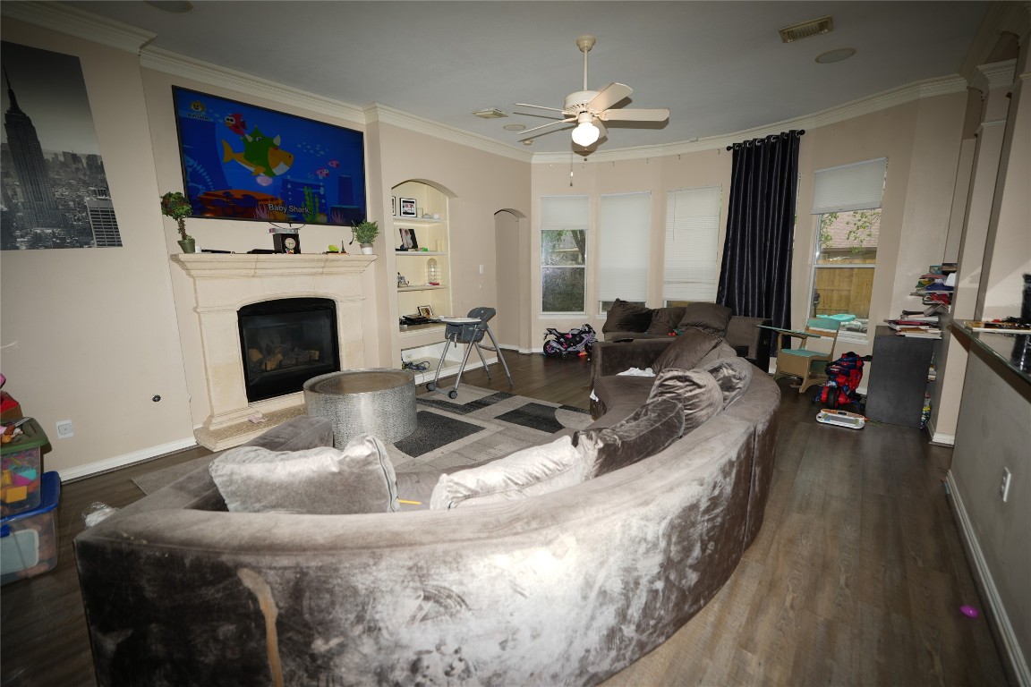 12711 Big Spring Trail Humble, TX 77346 - Photo 16 of 25 a living room with furniture a fireplace and a flat screen tv