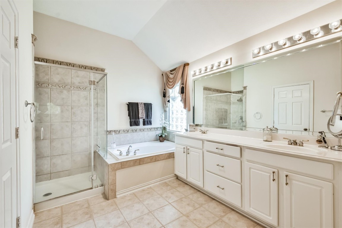 12711 Big Spring Trail Humble, TX 77346 - Photo 18 of 25 a spacious bathroom with a double vanity sink mirror double and bathtub
