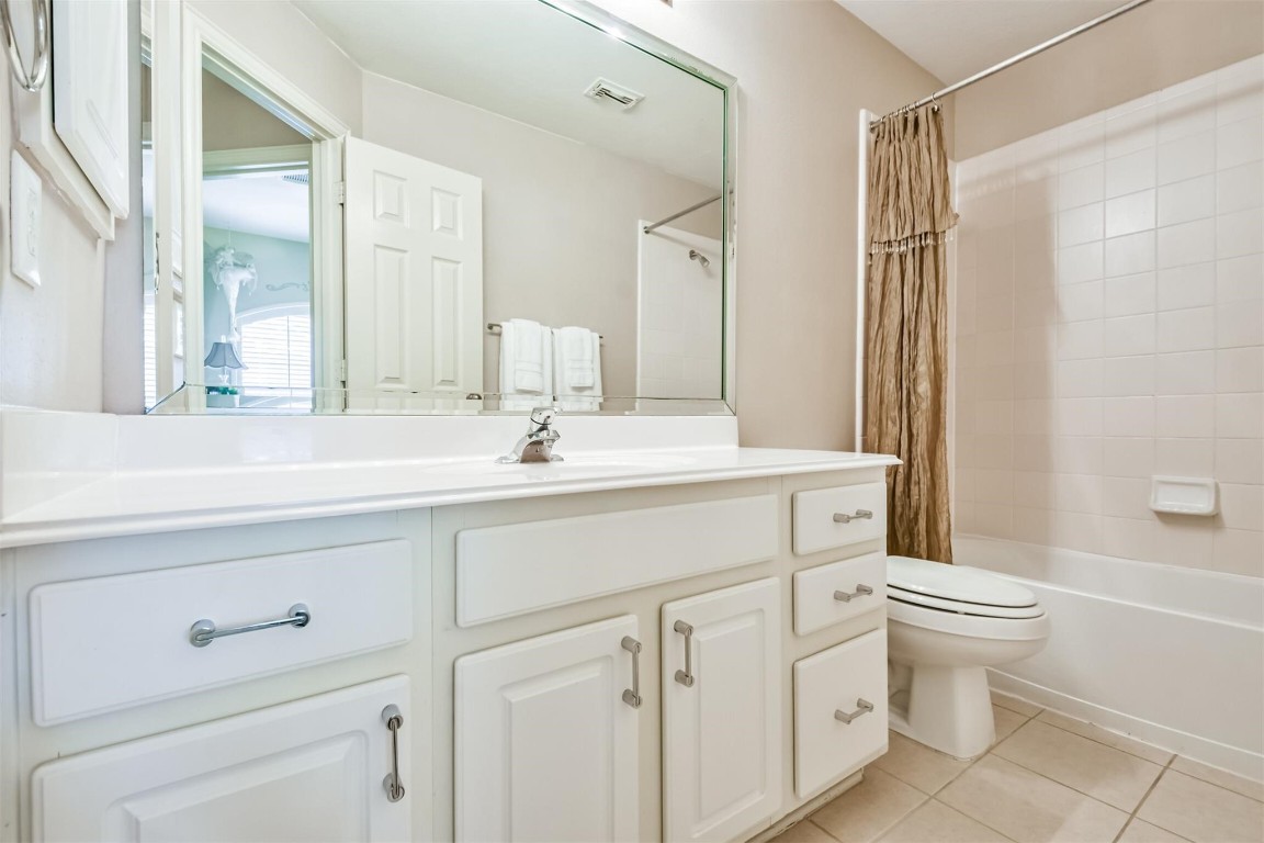 12711 Big Spring Trail Humble, TX 77346 - Photo 21 of 25 a bathroom with a double vanity sink mirror and toilet